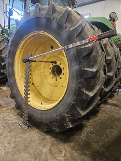 Torque wrench and extension resting in the torque tree beside a large tractor tire